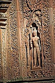 Banteay Srei temple - sculpted male guardian in niches